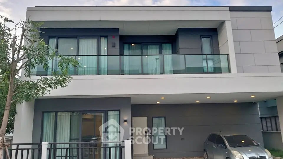 Modern two-story house with large balcony and sleek design