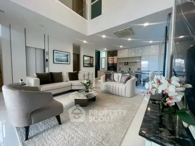 Luxurious modern living room with elegant furniture and open kitchen layout, perfect for stylish urban living.