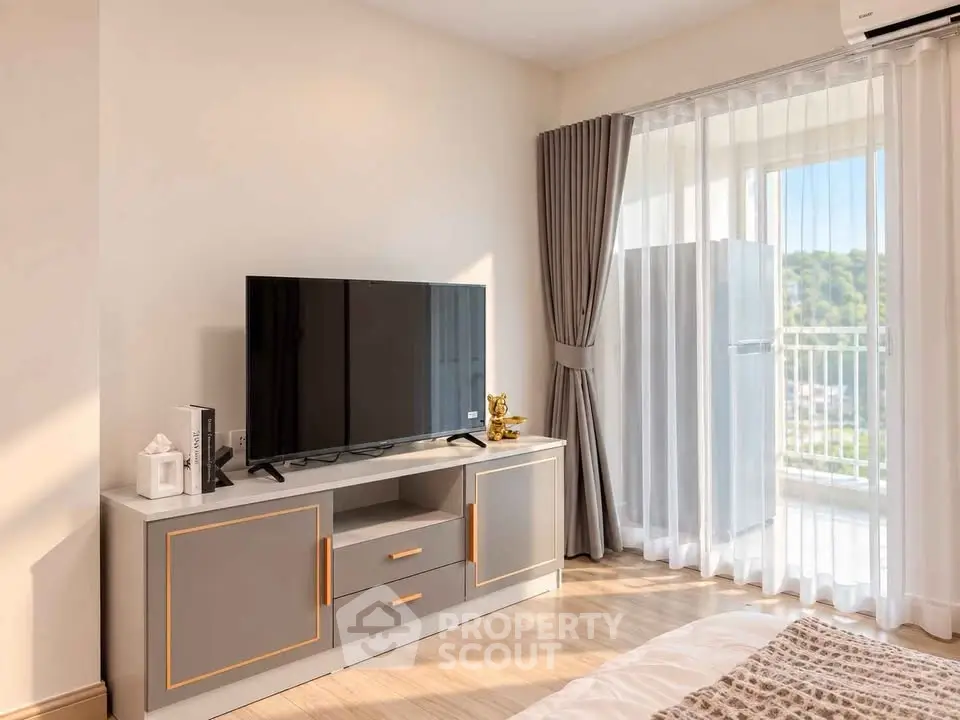 Modern bedroom with stylish TV stand and large window offering scenic views.