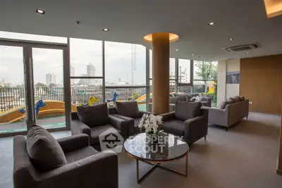 Spacious living room with modern furniture and city view, perfect for relaxation and entertaining.