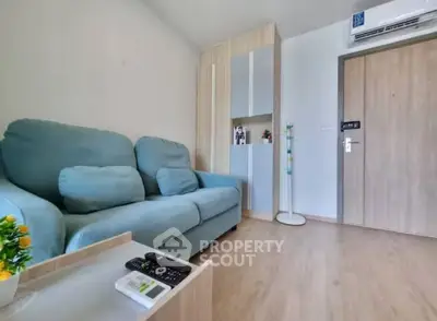 Cozy living room with modern sofa and air conditioning in a stylish apartment.