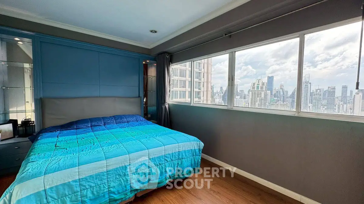 Spacious bedroom with stunning city view and modern decor