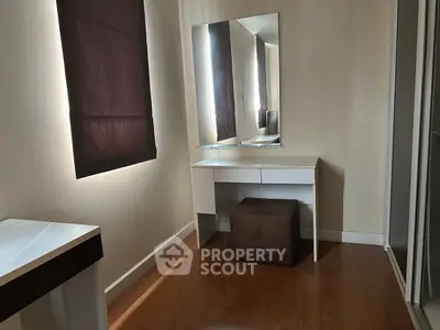 Cozy corner with modern vanity and mirror in a well-lit room