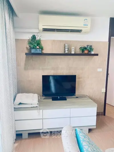 Charming living room with modern decor, air conditioning, and stylish shelving, perfect for cozy relaxation.