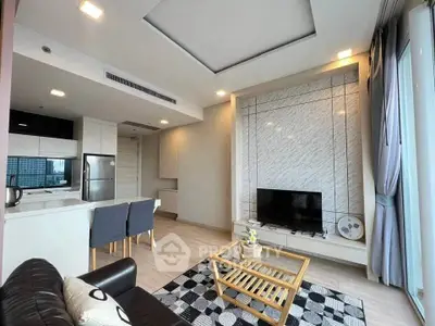 Modern living room with open kitchen, stylish decor, and large windows offering city views.