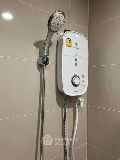 Modern bathroom with sleek shower unit and elegant tiled walls.