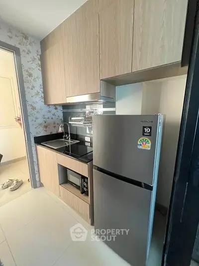 Modern compact kitchen with sleek appliances and stylish cabinetry