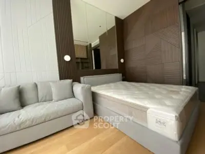 Modern bedroom with stylish wood paneling and cozy gray sofa