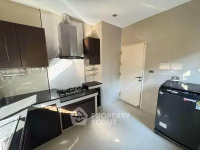 Modern kitchen with sleek cabinets and gas stove in a bright, spacious layout.