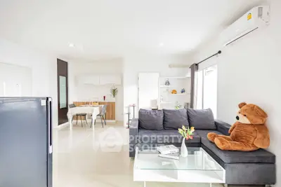 Modern living room with cozy sofa, dining area, and stylish decor