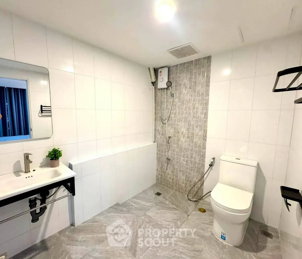 Spacious modern bathroom with sleek fixtures and stylish tile design