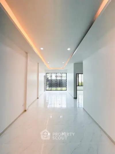 Spacious modern living room with elegant lighting and large windows