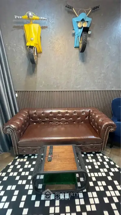Stylish living room with leather sofa and unique motorcycle wall decor