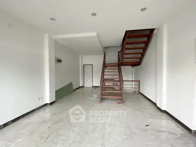 Spacious interior with modern staircase and marble flooring, ideal for customization.