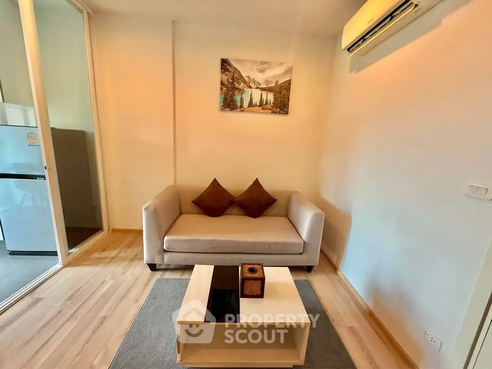 Cozy living room with modern sofa, air conditioning, and stylish decor in a contemporary apartment.