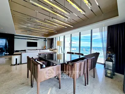 Luxurious modern living room with stunning ocean view and elegant dining area.