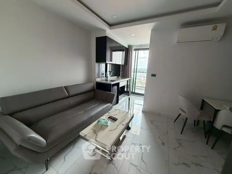 Modern living room with sleek furniture and open kitchen layout