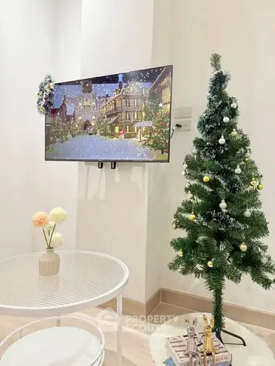 Cozy living room with festive decor and wall-mounted TV