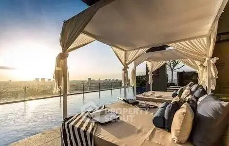 Luxurious rooftop pool with cabanas offering stunning city views at sunset.