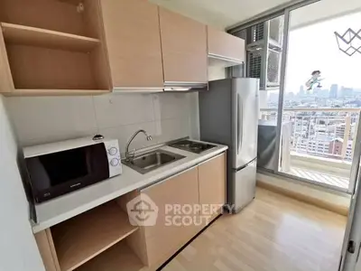 Modern kitchen with sleek cabinetry and city view from balcony