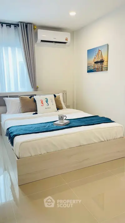 Modern bedroom with stylish decor and air conditioning, perfect for relaxation.