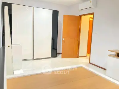 Modern minimalist bedroom with sleek wardrobe and air conditioning
