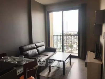 Modern living room with city view, featuring sleek furniture and large windows for natural light.