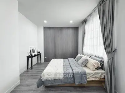 Modern minimalist bedroom with stylish decor and natural light