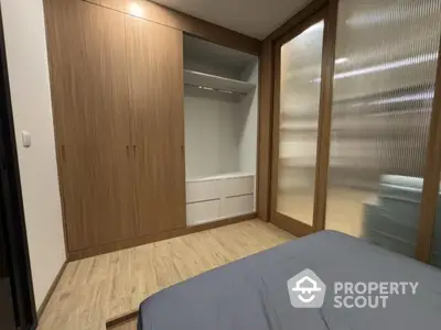 Modern bedroom with built-in wooden wardrobe and cozy ambiance