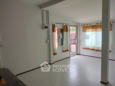 Bright and airy living room with large windows and modern decor.