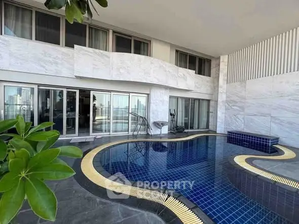 Luxurious poolside area with modern architecture and city view