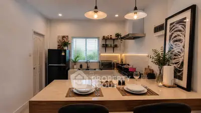 Modern kitchen with open layout, stylish lighting, and sleek appliances for a contemporary living experience.