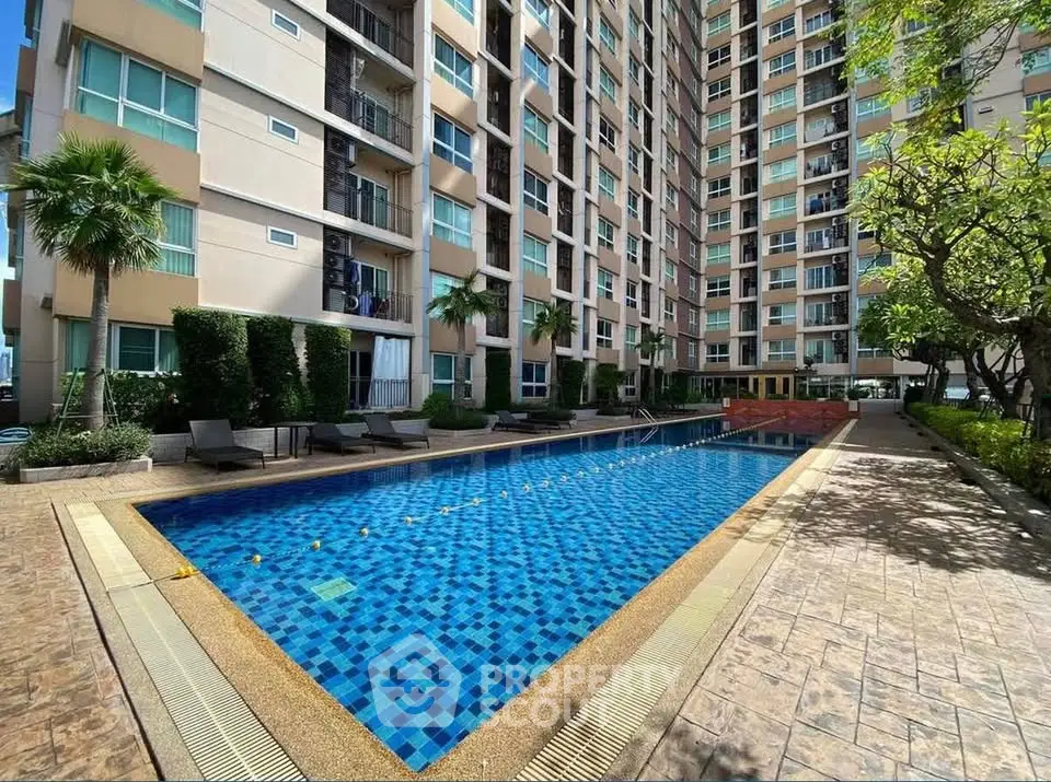 Luxurious condominium with a stunning outdoor pool and lush greenery, perfect for relaxation and leisure.