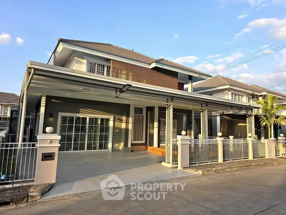Stunning modern two-story house with spacious driveway and elegant exterior design in a serene neighborhood.