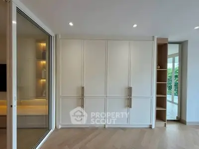 Spacious modern living room with elegant built-in storage and large windows