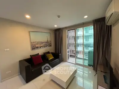 Modern living room with sleek furniture and large windows in a high-rise apartment.