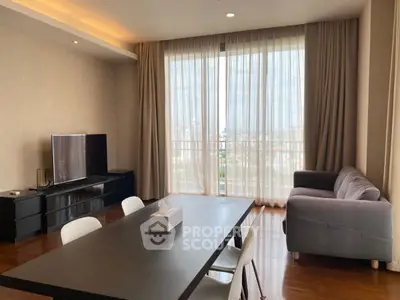 Spacious living room with modern furniture and large window view.