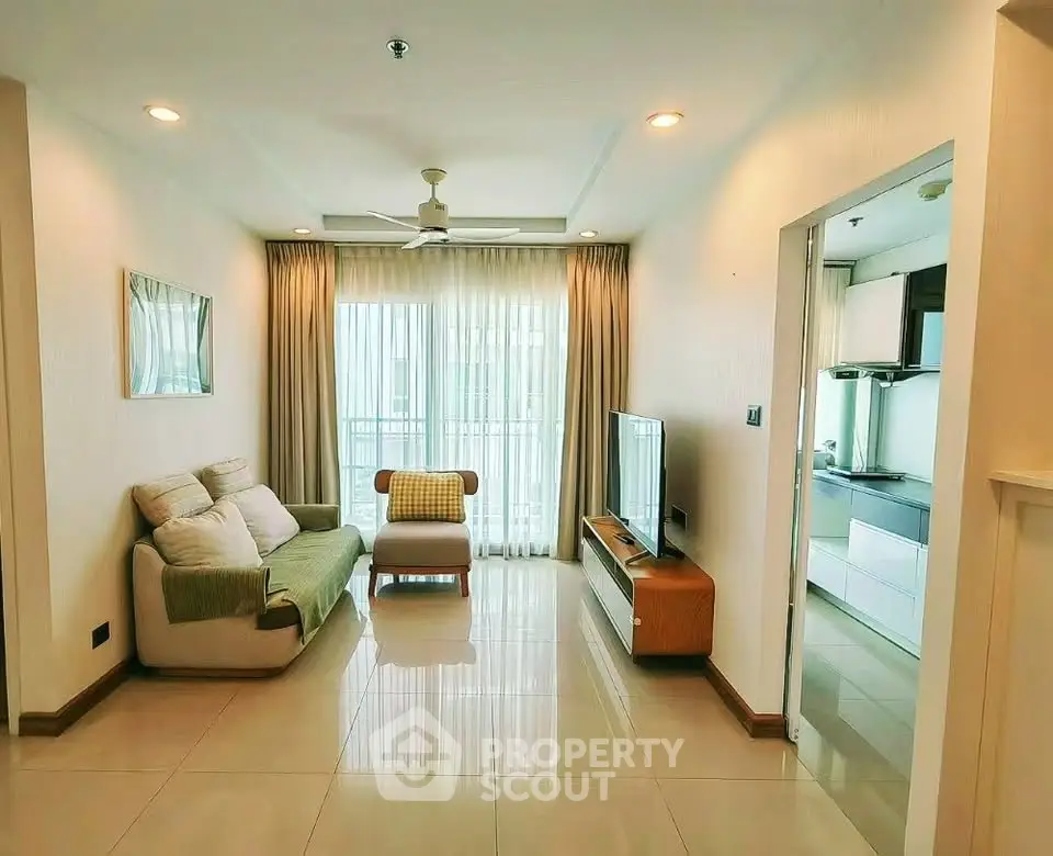 Spacious living room with modern decor and natural light in a stylish apartment.