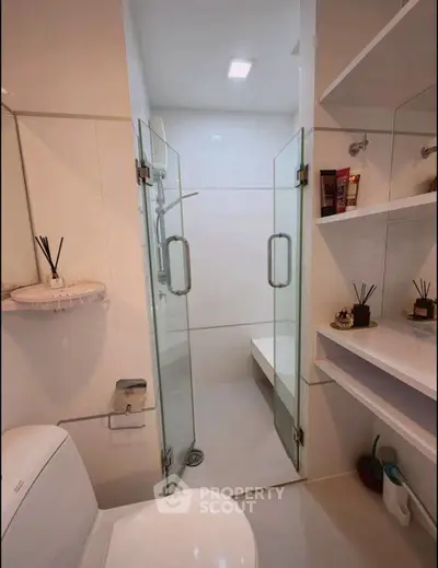 Modern bathroom with glass shower and sleek shelving