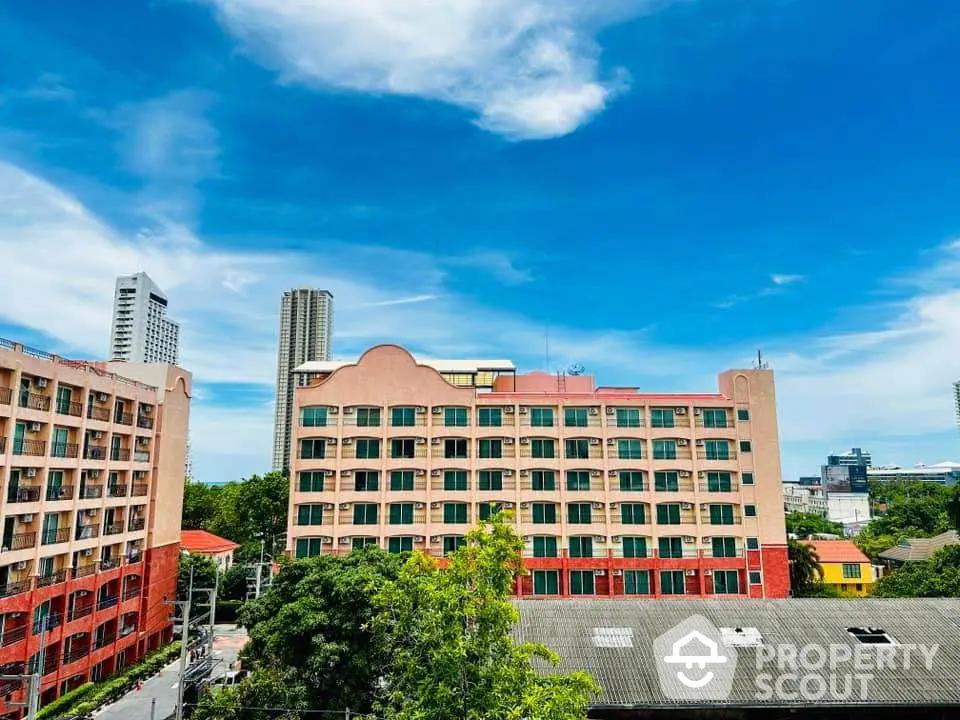 Stunning urban view of colorful apartment buildings under a vibrant blue sky.