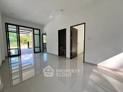 Spacious modern living room with large windows and glossy tiled floors