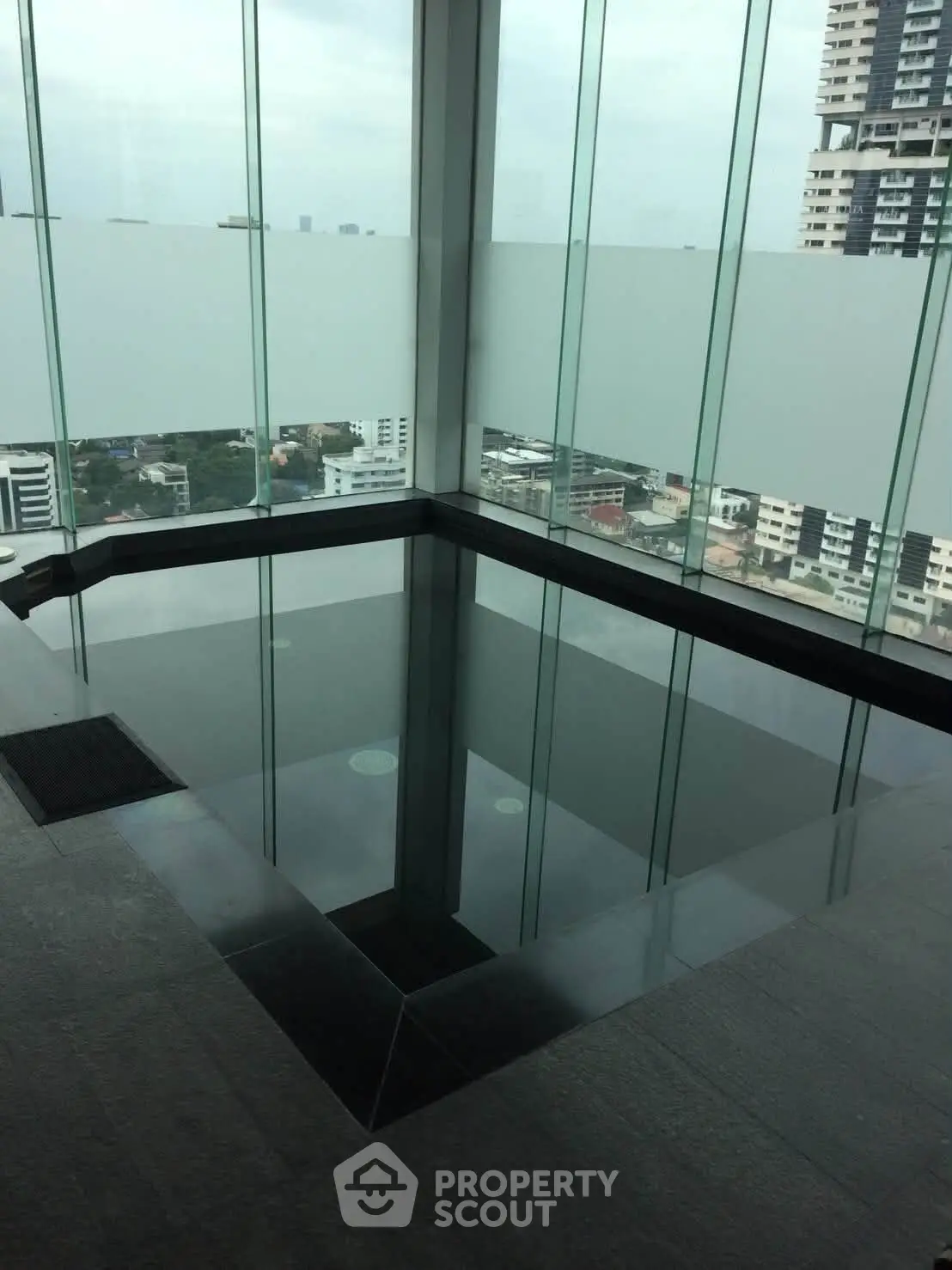 Luxurious rooftop pool with stunning city views in modern high-rise building.