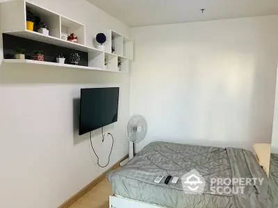 Cozy bedroom with wall-mounted TV and modern shelving