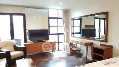 Spacious living room with modern furniture and large windows for natural light.