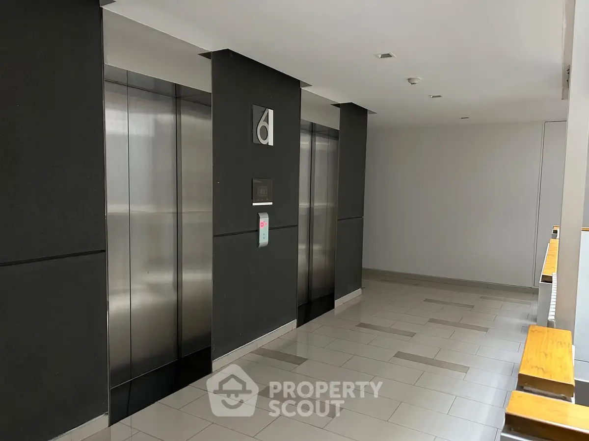 Modern building elevator lobby with sleek design and polished floors.