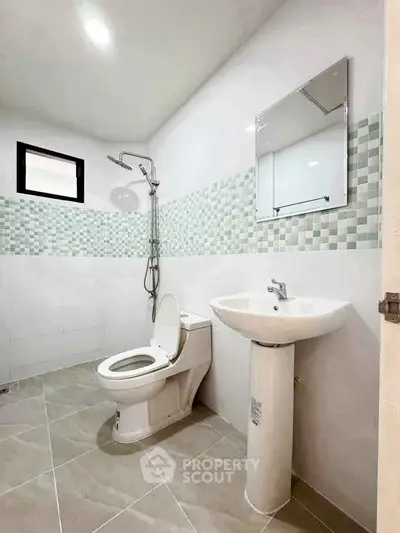 Modern bathroom with sleek fixtures and stylish tile design, perfect for contemporary living.