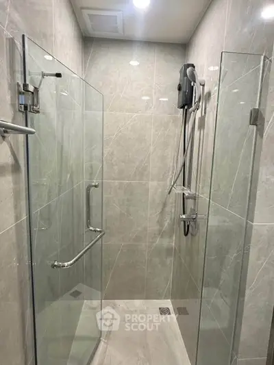 Modern bathroom with glass shower enclosure and sleek fixtures