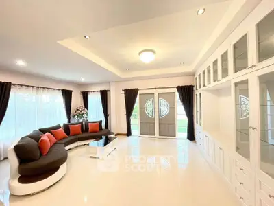 Spacious and elegant living room with modern decor and large windows.