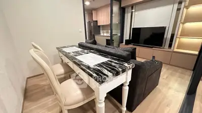 Modern living room with elegant dining area and sleek TV setup