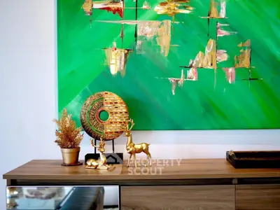 Stylish modern interior with vibrant green abstract art and elegant decor on wooden console.